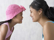 Portrait of mother and daughter kissing