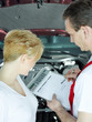 Female customer and motor mechanic checking offer details