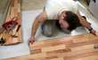 Young man laying the floor panels
