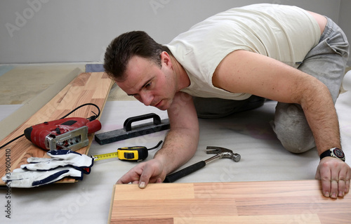 Photo: Laying of the panels by a young man Laying of the panels by a young man