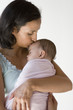 Mother kissing her sleeping baby