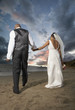 Newlyweds walking on the beach
