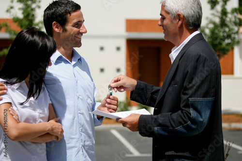 Photo: Couple receiving the keys to their new apartment Couple receiving the keys to their new apartment