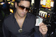 Young man holding his winnings at the casino