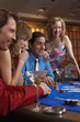 People playing at a blackjack table