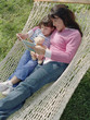 Mother and daughter reading in a hammock
