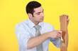 Man applying varnish to a wooden plank