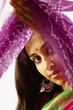Portrait of young woman holding up a sari