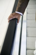 Businessman's hand on rail