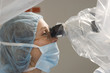 Foto: Surgeon Using Operating Microscope Surgeon Using Operating Microscope