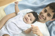 Young father and baby son posing