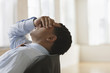 Businessman covering eyes