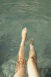 Young woman's legs playing in water