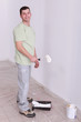 Man painting wall with roller