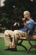 Man playing guitar on park bench