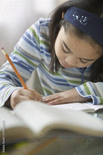 Photo: Young girl doing her homework Young girl doing her homework
