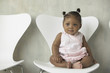 Portrait of baby girl sitting in chair