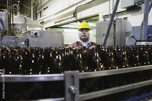 Photo: Man working in bottling plant Man working in bottling plant