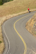 Male runner on winding rural road