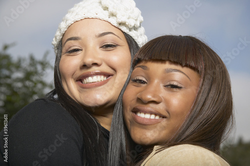 Photo: Two African American women smiling and hugging Two African American women smiling and hugging