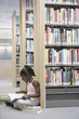Girl reading book in library