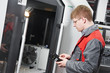 Photo: worker operating CNC machine center worker operating CNC machine center