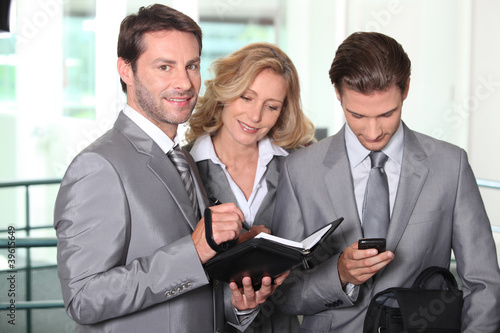Photo: Business colleagues checking agenda Business colleagues checking agenda
