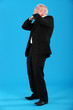 Well-dressed man covering his face with his hands