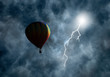 Hot-Air Balloon Among Dark Storm Clouds with Lightning