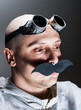 Man wearing false moustache and goggles