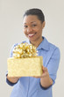 Woman smiling while offering a gift