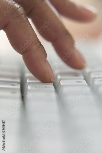 Photo: Close up of fingers typing on keyboard Close up of fingers typing on keyboard