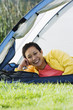 Woman smiling for the camera in a tent