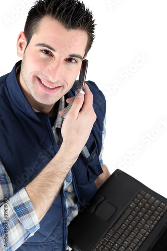 Photo: Handsome man listening to a voice message Handsome man listening to a voice message