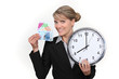 Woman holding clock and bank notes