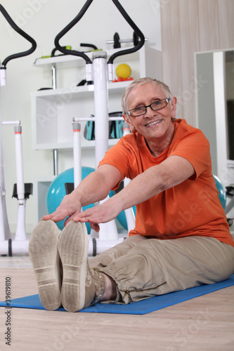 Photo: Older woman working out on a gym mat Older woman working out on a gym mat