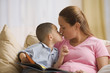 Mother and son kissing as they read together