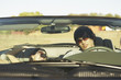 Couple driving a convertible