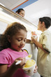 Photo: Brother and sister eating ice cream in ice cream shop Brother and sister eating ice cream in ice cream shop