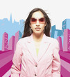 Woman posing for the camera in sunglasses against city background