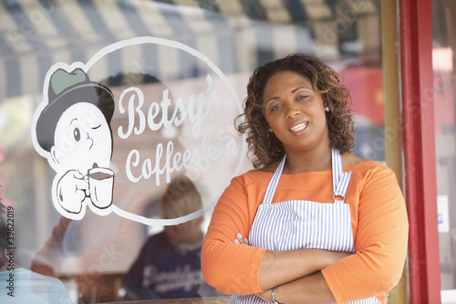 Photo: Portrait of woman in front of coffee shop Portrait of woman in front of coffee shop