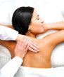 Pretty woman relaxing while getting a back massage