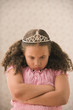 Young girl pouting with princess crown