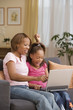Mother and daughter using a laptop together