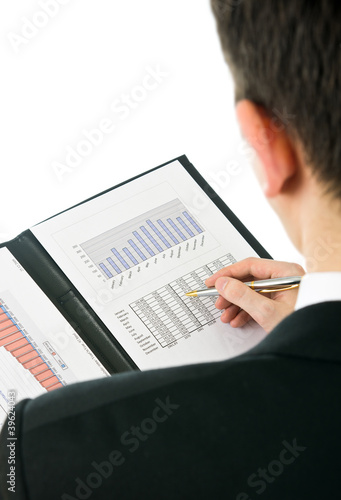 Photo: Businessman checking financial results isolated on white Businessman checking financial results isolated on white