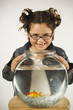 Young girl holding a fishbowl