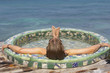 Young woman relaxing in a hot tub