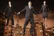 Businesspeople floating above the city