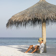 Young man asleep at the beach
