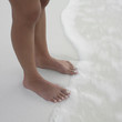 Woman's feet in the waves at the beach